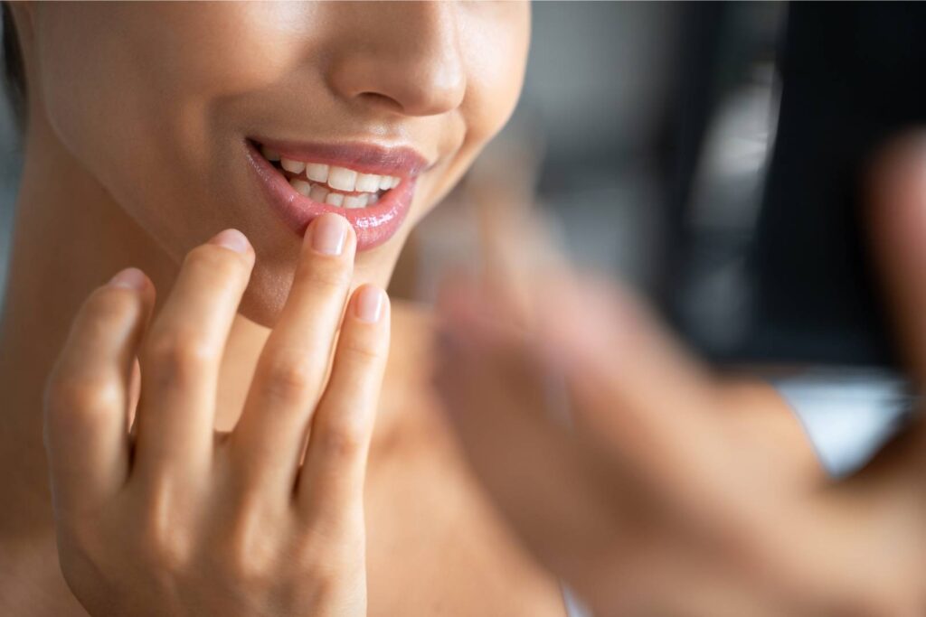 Cacao and skincare - woman applying lip balm.